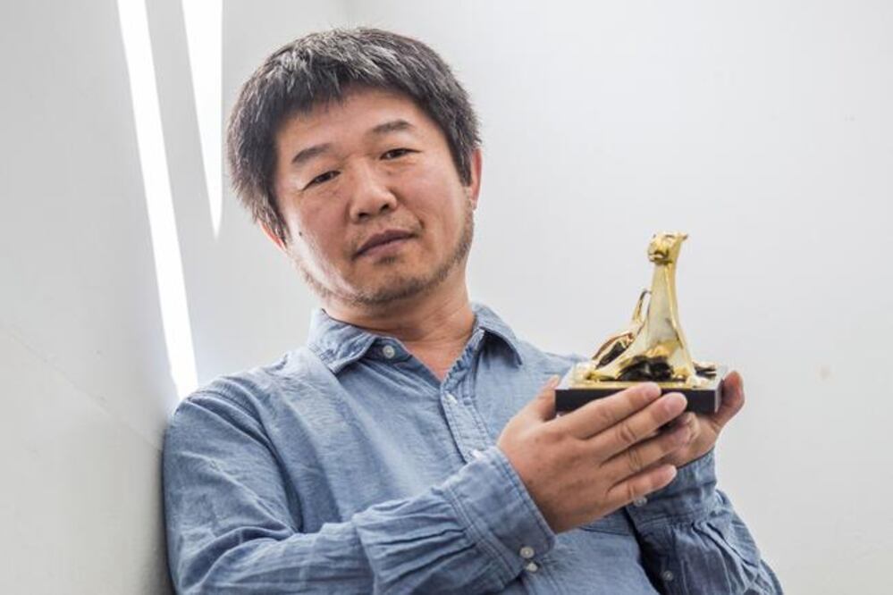Wang Bing, director del documental, muestra su premio (AFP)