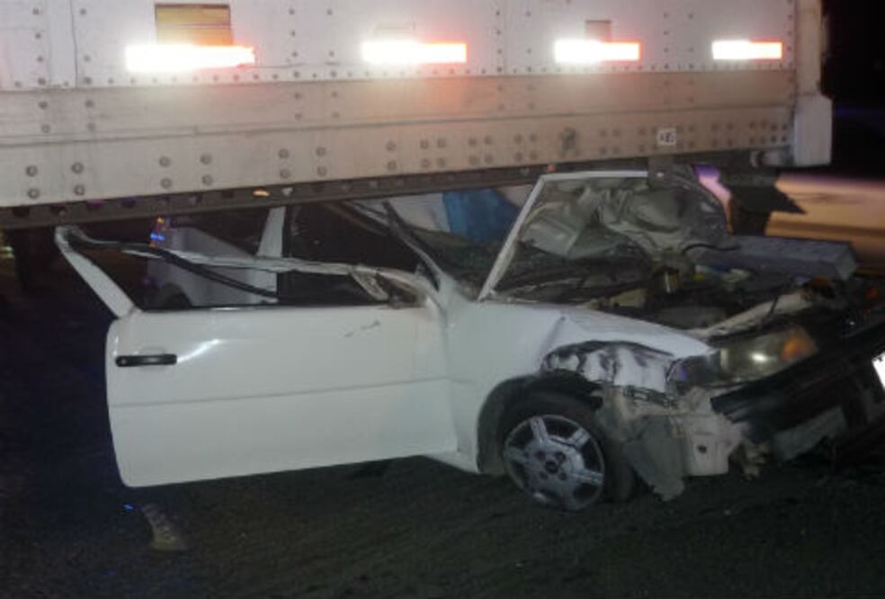 Conductor queda bajo un tráiler 