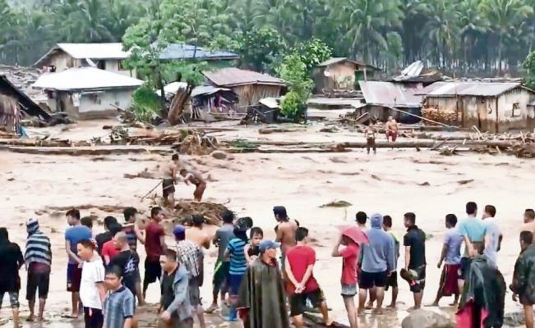 AP Imagen de video que muestra a lugareños intentando ponerse a salvo de los ríos desbordados en Lanao del Norte, al sur de Filipinas, debido a la tormenta Tembin. (AP)