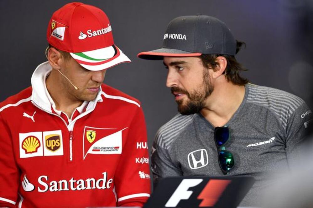 Sebastian Vettel y Fernando Alonso apoyan la nueva medida. (ANDREJ ISAKOVIC. AFP)