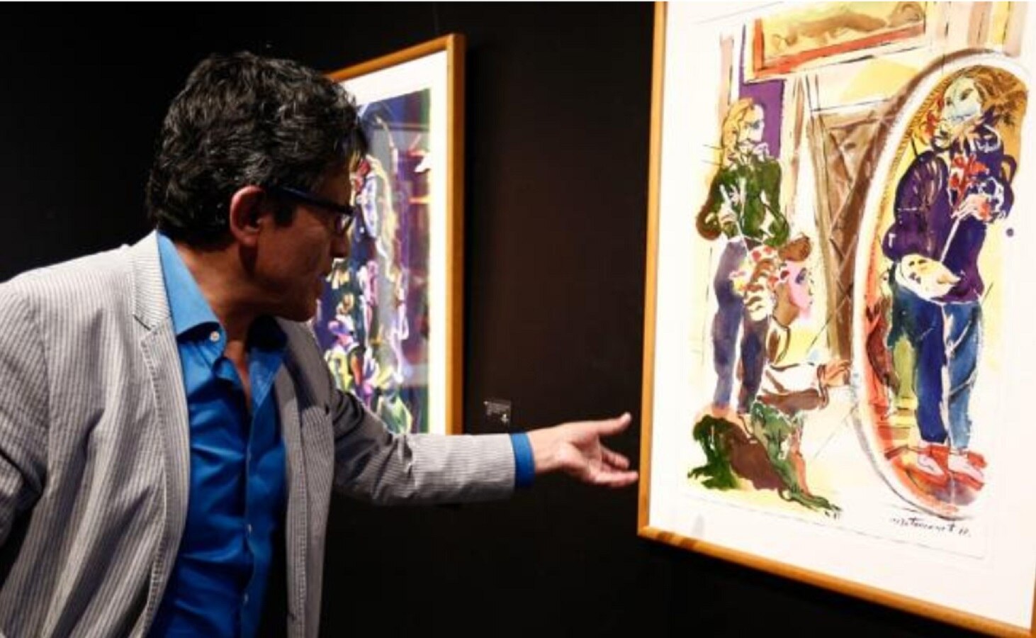 El pintor ecuatoriano Miguel Betancourt muestra una obra de su exposición "Ninfas, meninas y la mirada del pintor". Foto: EFE/José Jácome