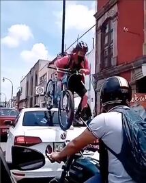 Video. Ciclista pasa por encima de automóvil; obstruía su paso